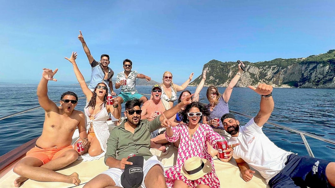 Group enjoying a boat tour near Capri's coastline, Sorrento.