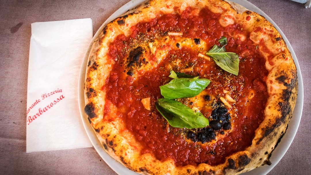 Pizza with tomato sauce and basil served at a restaurant in Capri, Italy.