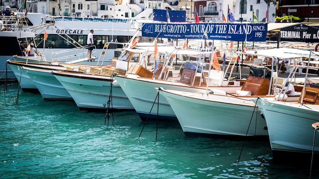 Boats docked at Capri port for Blue Grotto tour from Sorrento.