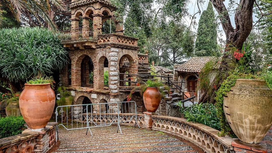 Historic stone structure with arches and large terracotta pots on a guided walking tour of Sorrento.