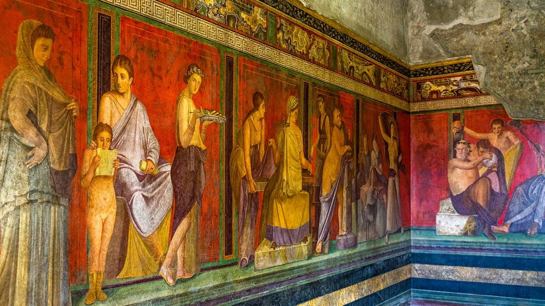 Ancient frescoes depicting figures in the Villa of the Mysteries, Pompeii.
