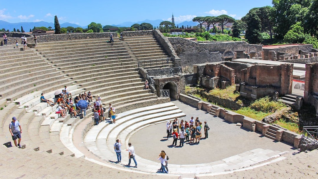 Tour group with guide in ancient theatre, Pompeii.