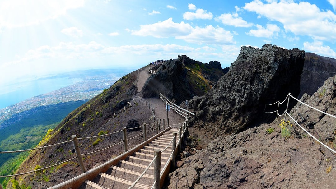 Pathway leading up Mt. Vesuvius with view of Naples coastline in the background.