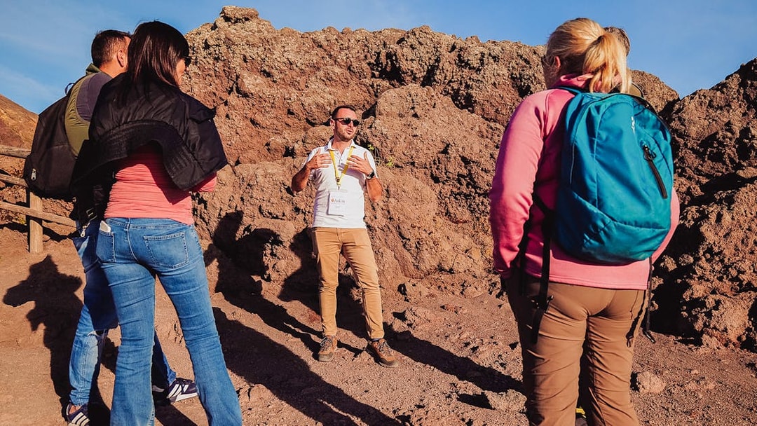 Tour guide explaining volcanic features to a group at Mt. Vesuvius, Italy.
