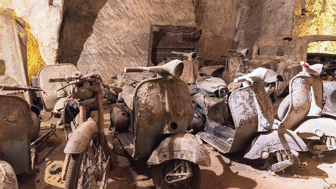 Abandoned scooters and cars in Naples Underground cave.