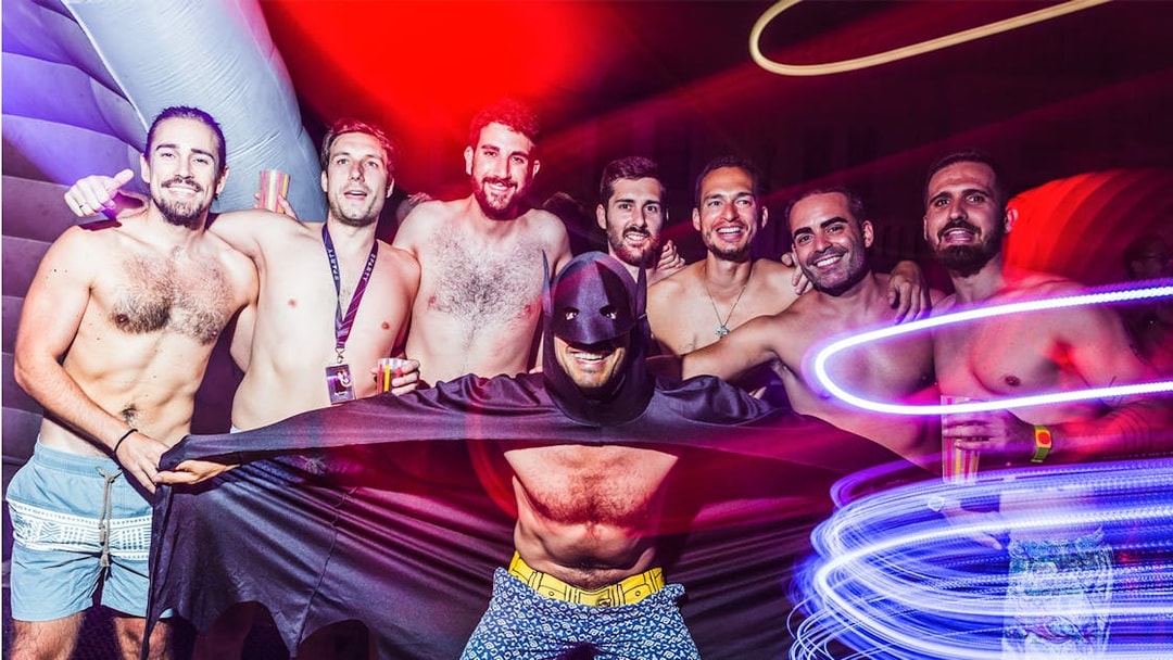 Group of friends enjoying Sparty bath party in Budapest with colorful lights.