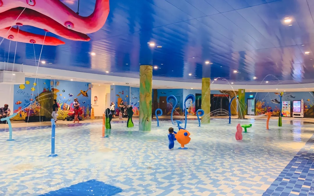 Indoor water play area with colorful fountains and marine-themed decor, Splash, Singapore.
