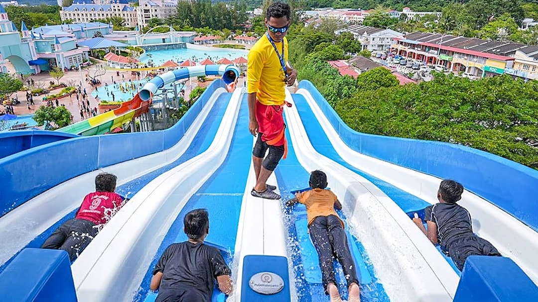 Visitors enjoying water slides at Splash Out Langkawi Water Theme Park, Malaysia.