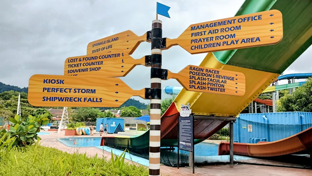 Signpost with directions to attractions at Splash Out Langkawi Water Theme Park, Malaysia.