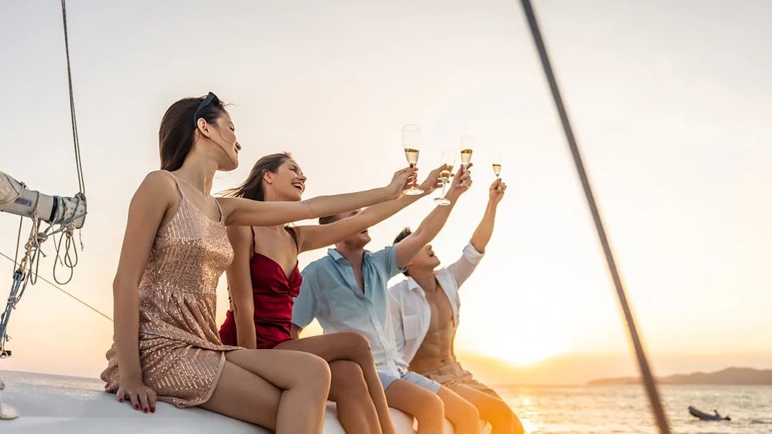 Group enjoying drinks on a Split Riviera cruise at sunset.