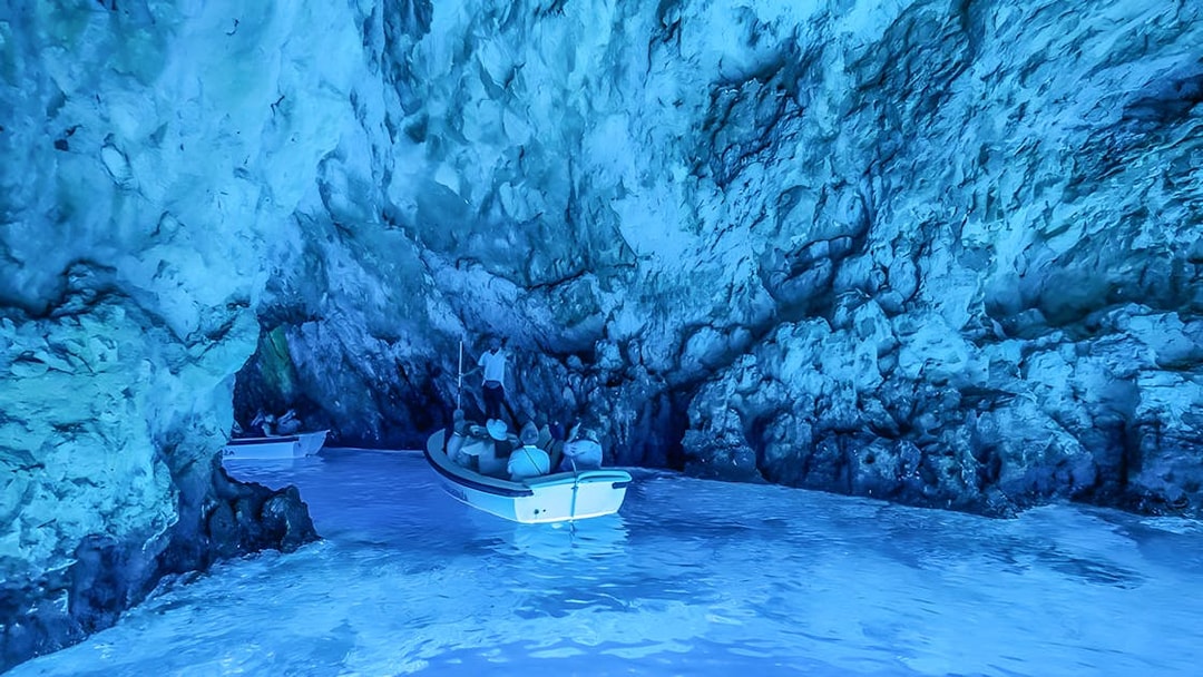 Visitors in a small boat explore the Blue Cave near Split.