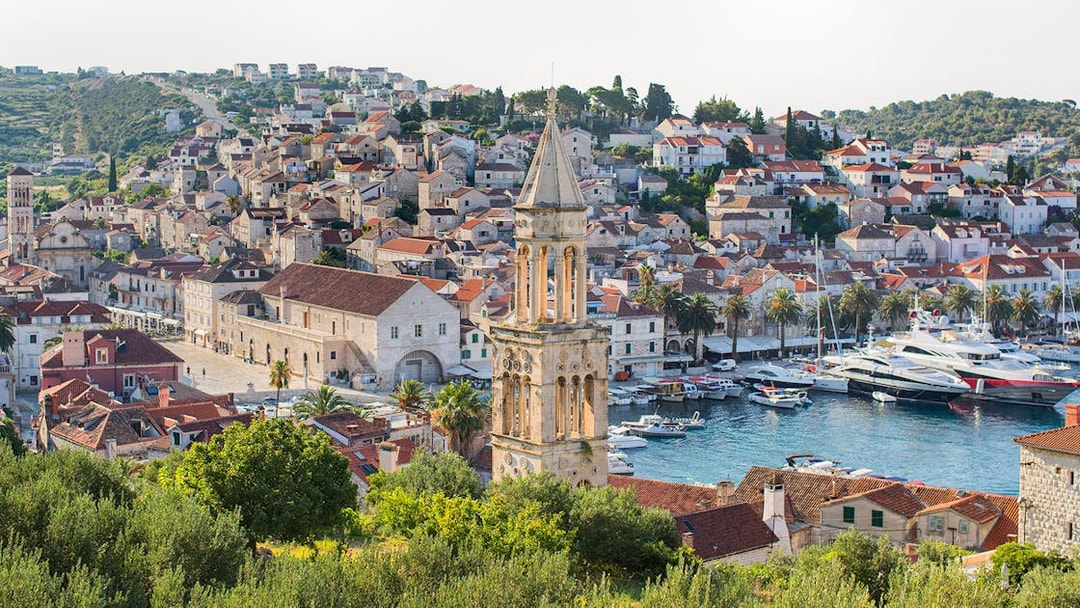 Harbor view of Hvar town with historic buildings and boats, part of Split's Blue Cave and 5 Islands tour.