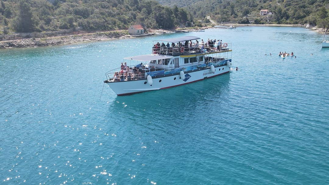 Cruise ship on Blue Lagoon near Split with passengers enjoying the view.