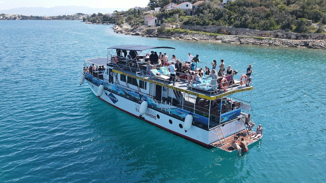 Tourists enjoying a boat cruise near the coast of Šolta, Croatia.