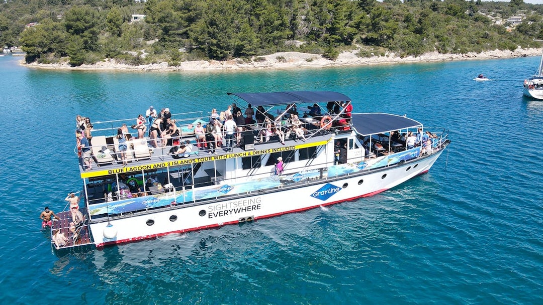 Cruise ship with tourists on Blue Lagoon tour near Split, Croatia.
