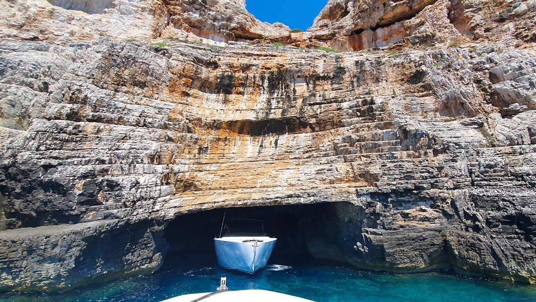 Boat entering Blue Cave on Vis Island, Croatia during a full-day tour from Split.