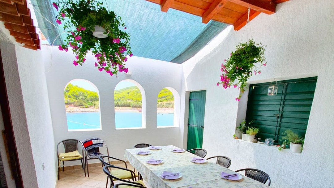 Dining area with sea view on a Split boat tour to Blue Cave, Vis, and Hvar.