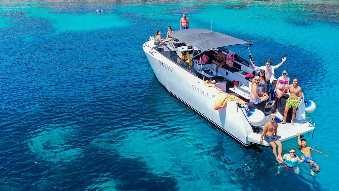 Boat tour group enjoying clear waters near Split, Croatia.