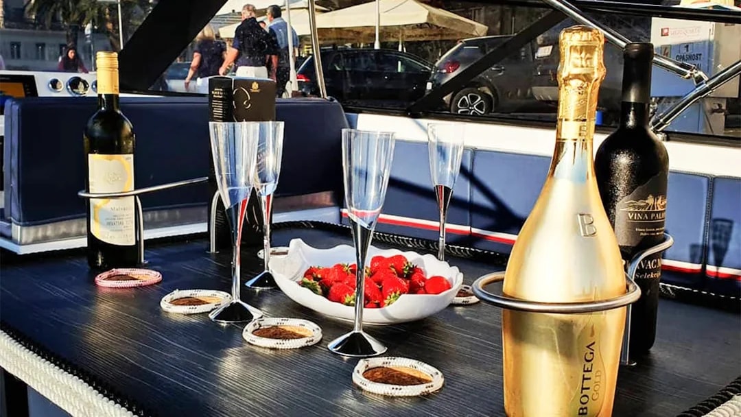 Champagne and strawberries on a boat deck during Split's Blue Cave, Vis, and Hvar tour.