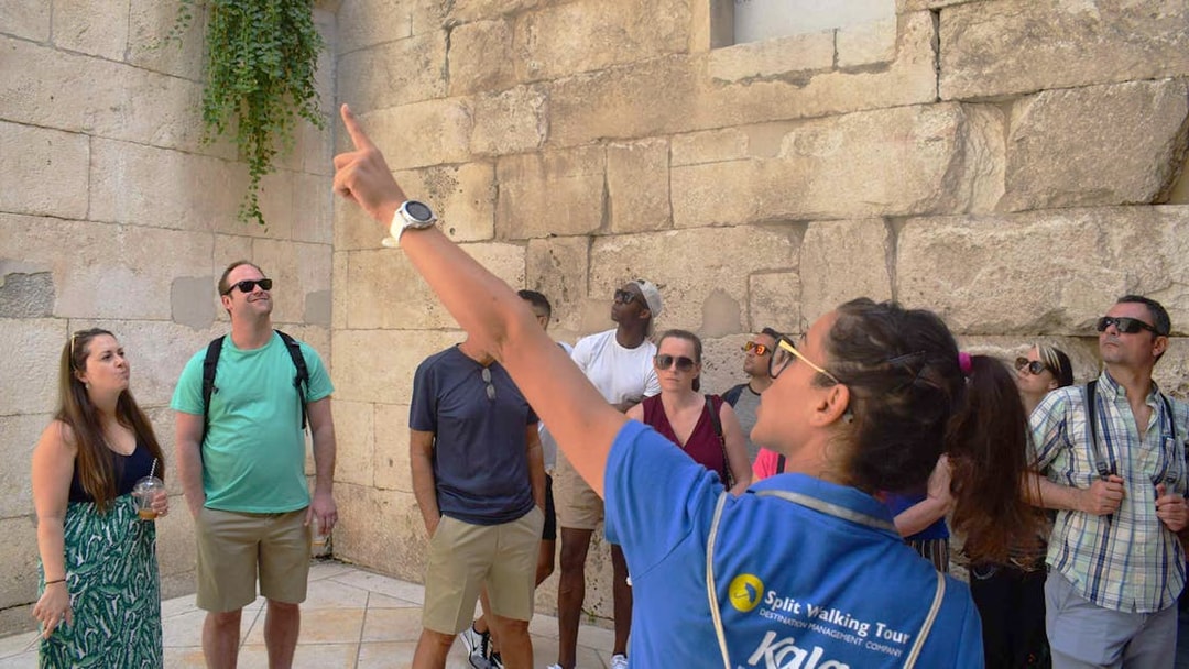 Tour guide leading a group at Diocletian's Palace in Split's Old Town.