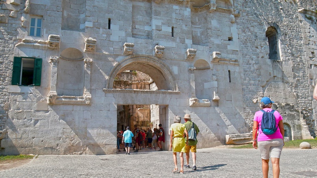 Visitors entering Diocletian's Palace through the Golden Gate in Split's Old Town.