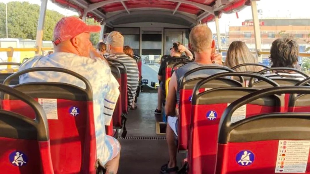 Tourists seated on an open-top bus during Klis Fortress sunset tour.