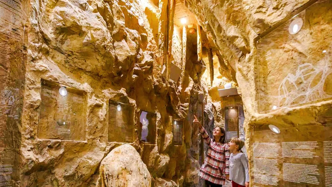 Visitors exploring a cave exhibit on the Split Panoramic Bus Tour.