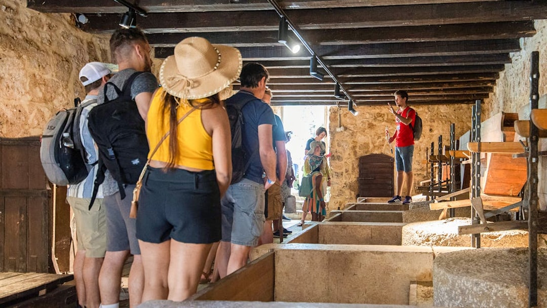 Tour group inside a historic building during Krka Waterfalls tour from Split.