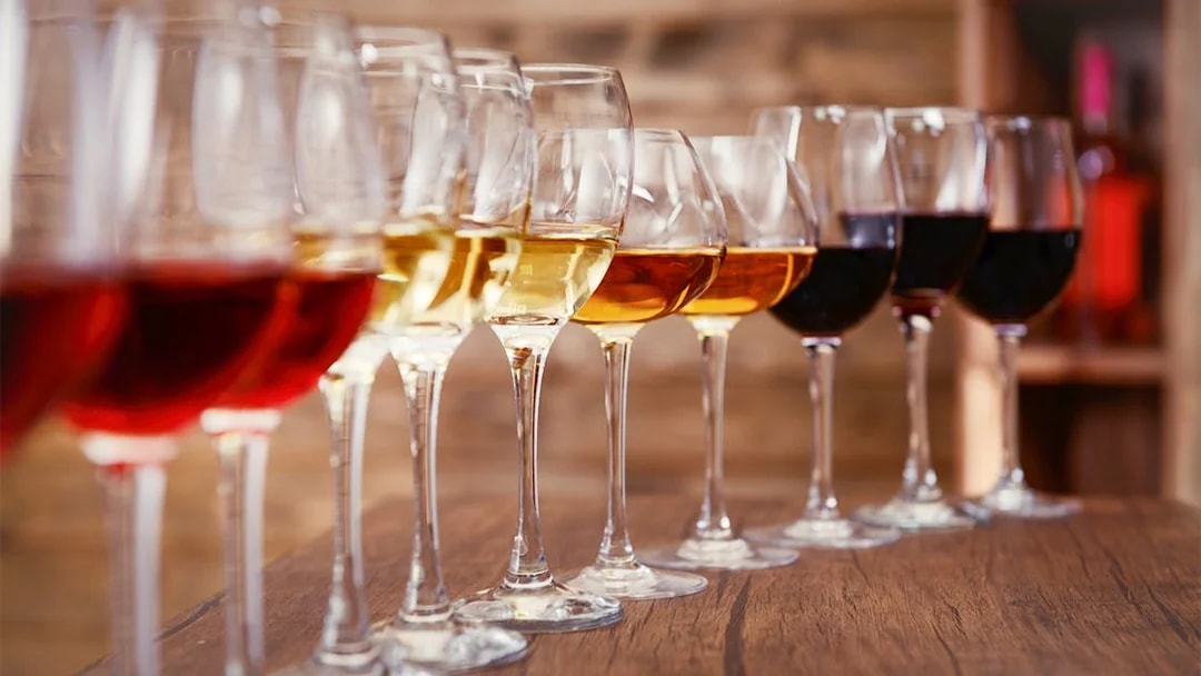 Wine glasses lined up on a wooden table, part of a Krka National Park tour from Split.
