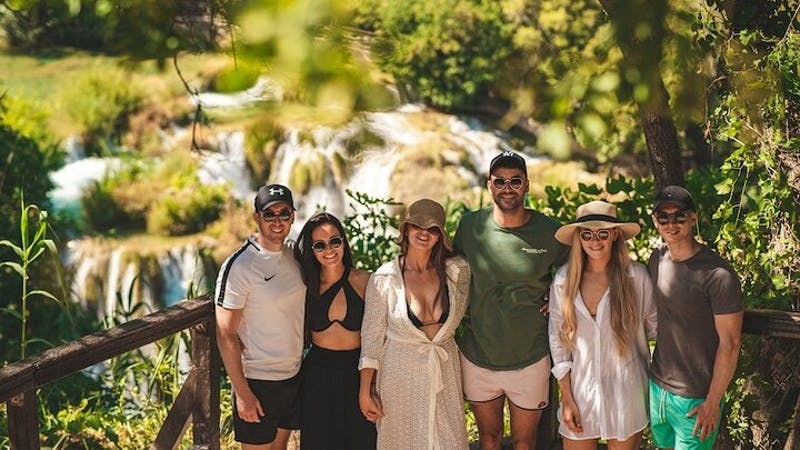 Group of tourists at Krka National Park waterfall during a tour from Split.