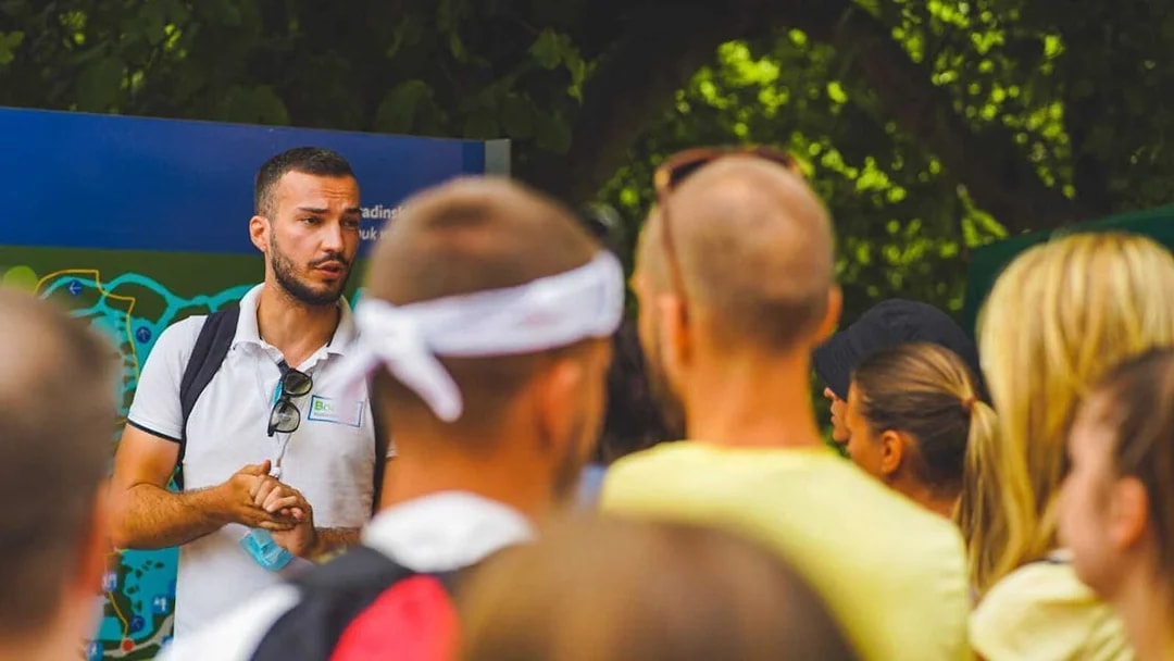 Tour guide explaining Krka National Park map to visitors from Split.
