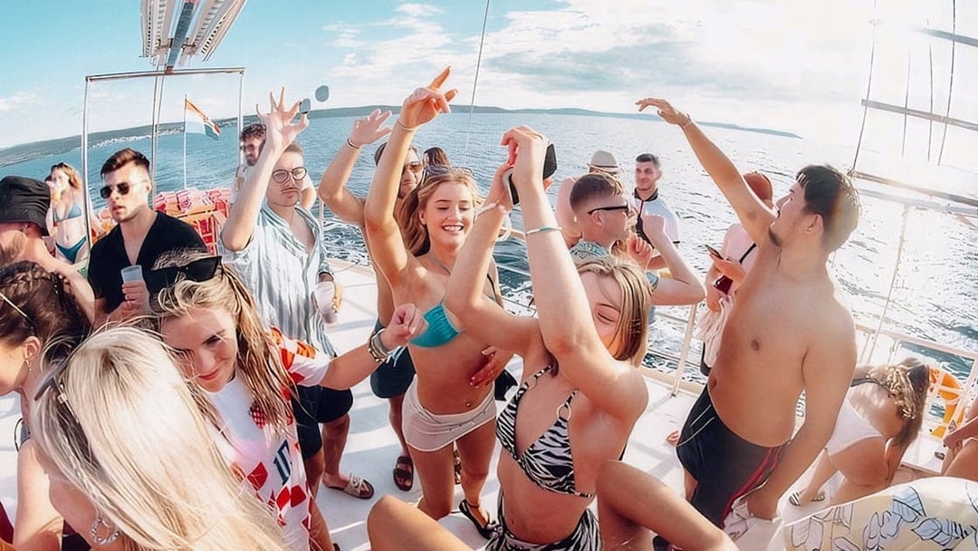 Guests dancing and enjoying the Split Party Cruise on a boat in the Adriatic Sea.