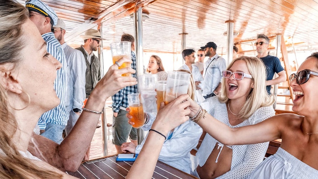 Guests toasting drinks on Split Party Cruise deck.
