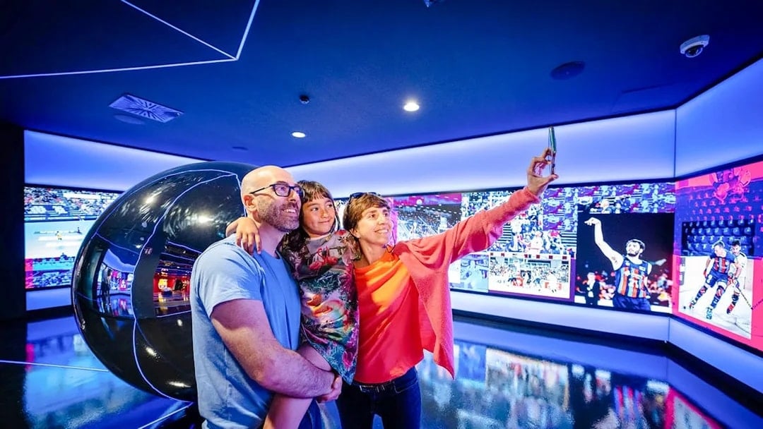Family taking a selfie at the Barça Museum in Spotify Camp Nou, Barcelona.