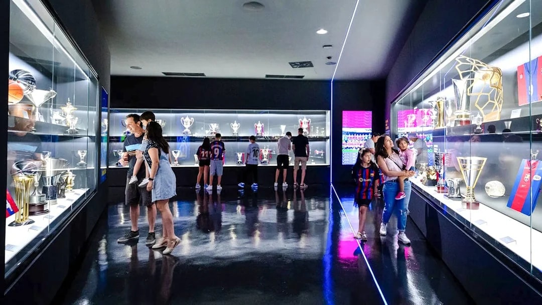 Visitors viewing trophies at the Spotify Camp Nou Barça Museum in Barcelona.