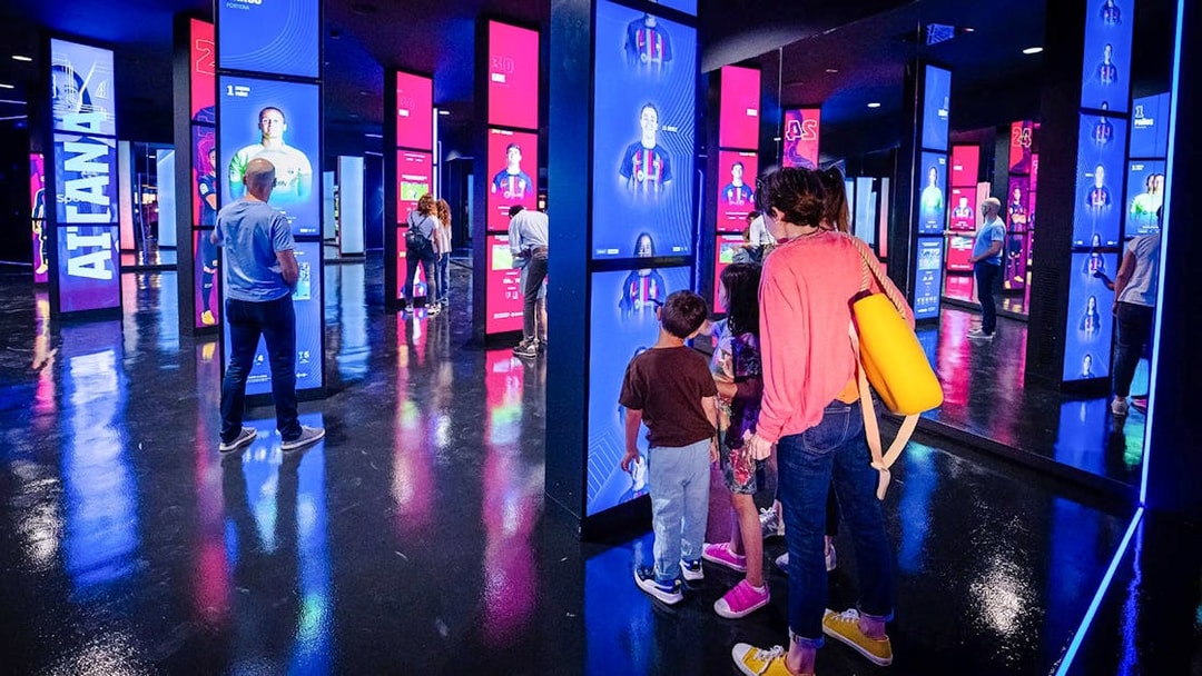 Visitors exploring interactive displays at the Spotify Camp Nou Barça Museum.