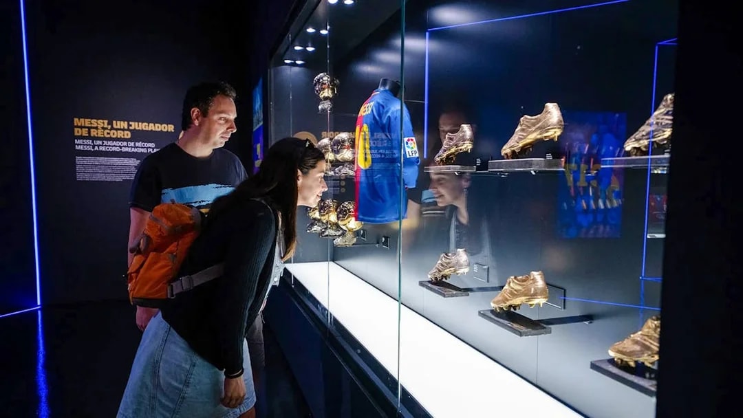 Visitors viewing Messi memorabilia at Spotify Camp Nou Barça Museum.