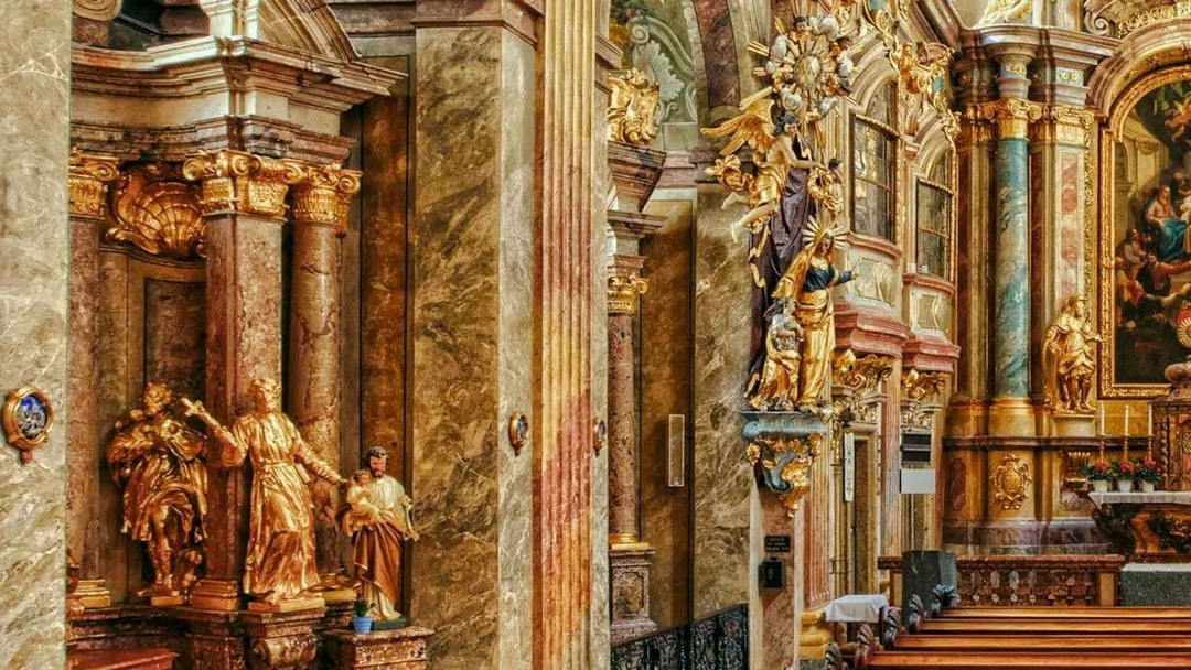 Ornate interior of St Anne's Church with gilded statues and detailed columns.