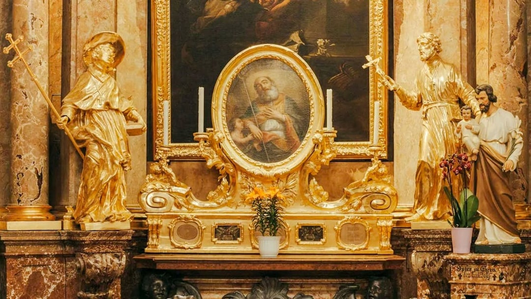 Golden altar with religious statues and painting inside St Anne's Church.