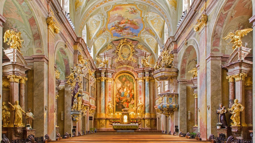 Interior of St Anne's Church with ornate altar and detailed frescoes.