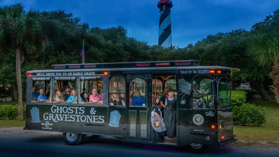 Trolley tour for St. Augustine Ghosts & Gravestones with lighthouse in background.
