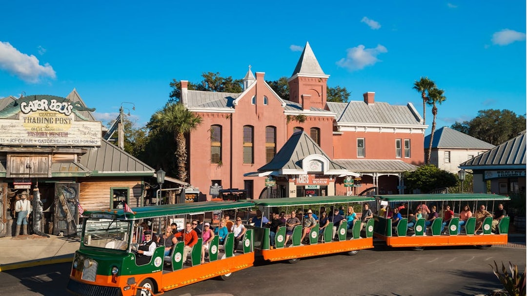 St. Augustine Old Town Trolley passing historic buildings and Gator Bob's Trading Post.