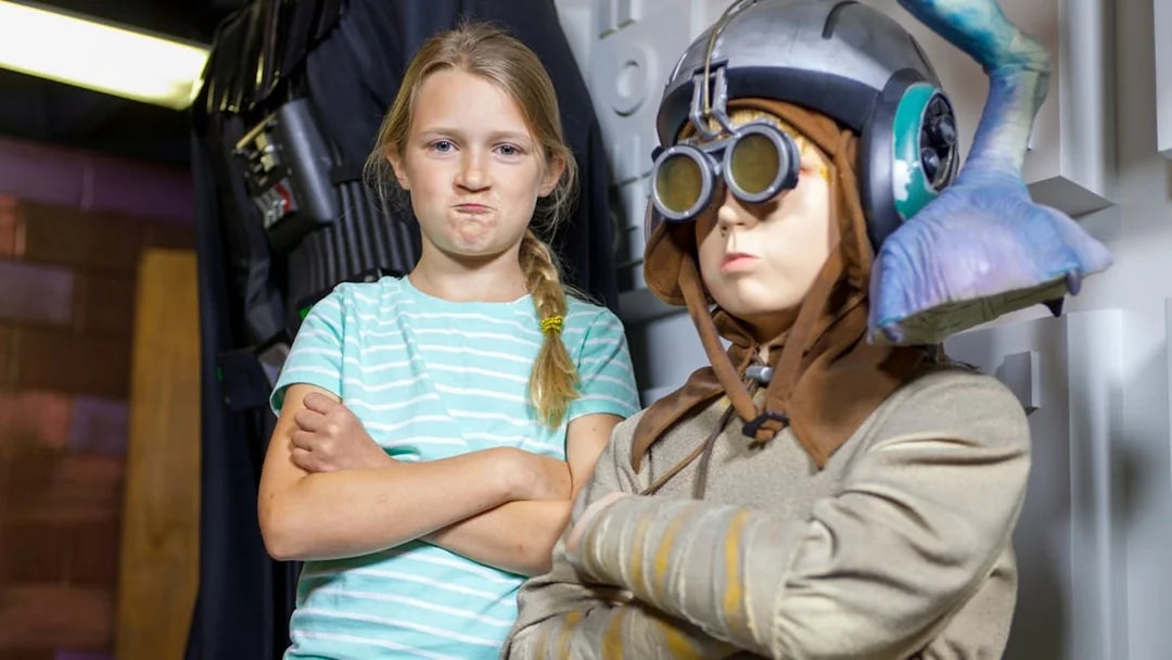 Child posing with a wax figure in St. Augustine Potter's Wax Museum.