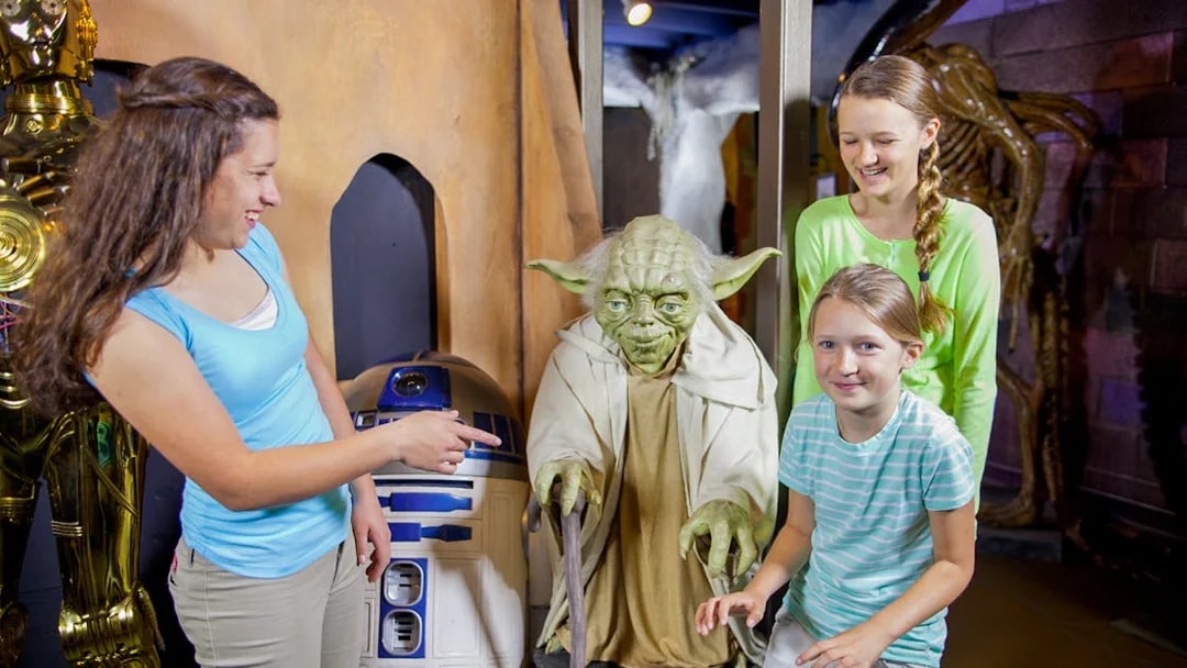 Visitors interacting with wax figures of iconic movie characters at St. Augustine Potter's Wax Museum.