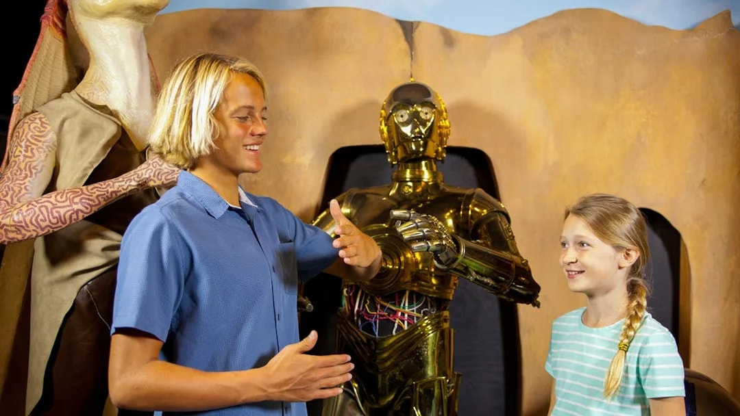Visitors interacting with wax figures of C-3PO and Jar Jar Binks at St. Augustine Potter's Wax Museum.