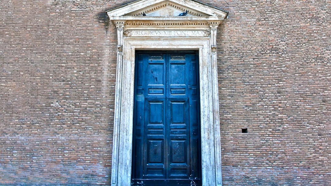 St. John Lateran entrance door in Rome, Italy, with detailed stonework.