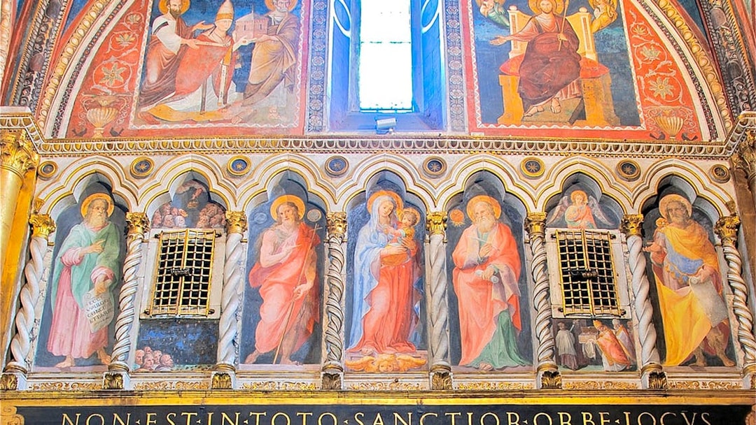 Frescoes inside St. John Lateran Basilica, Rome, depicting religious figures and ornate architecture.
