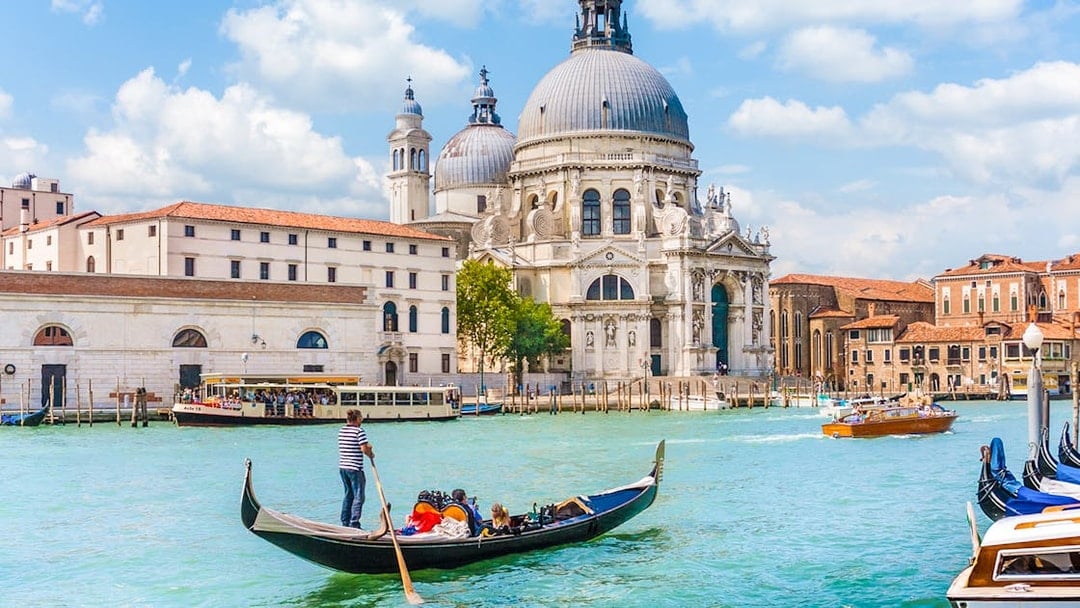 Gondola on Venice canal near St. Mark's Basilica during guided tour.