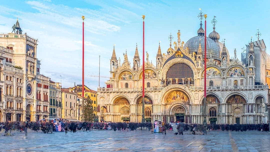 St Mark's Basilica facade with ornate arches and domes in Venice, Italy.