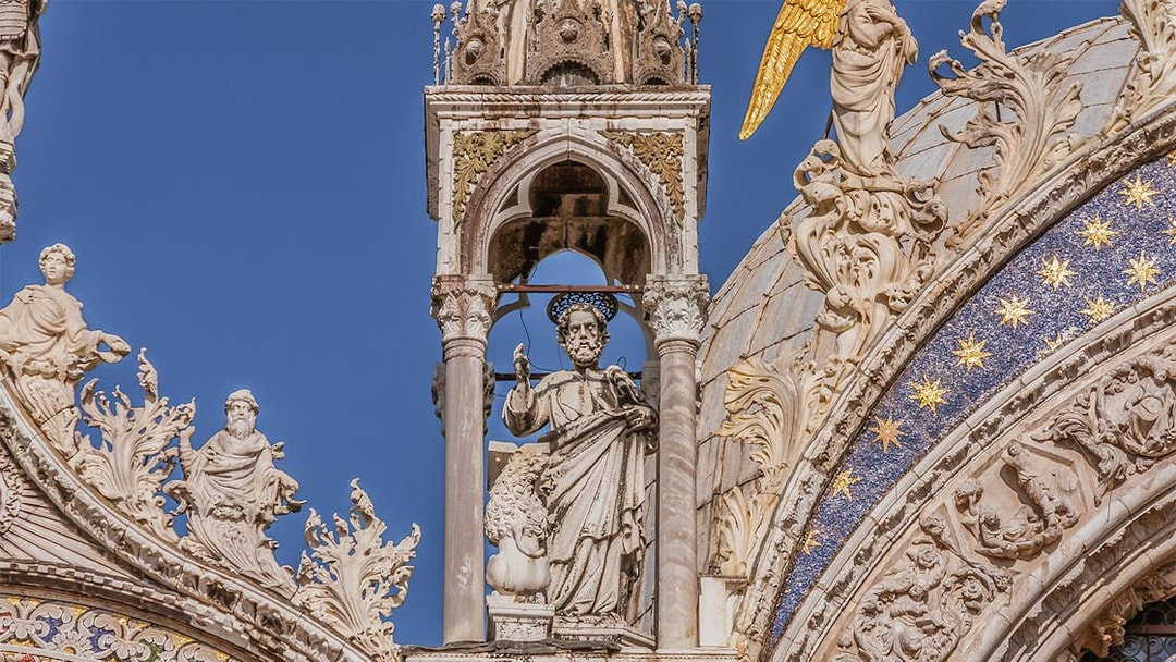 St. Mark's Basilica facade with detailed sculptures and ornate decorations in Venice.
